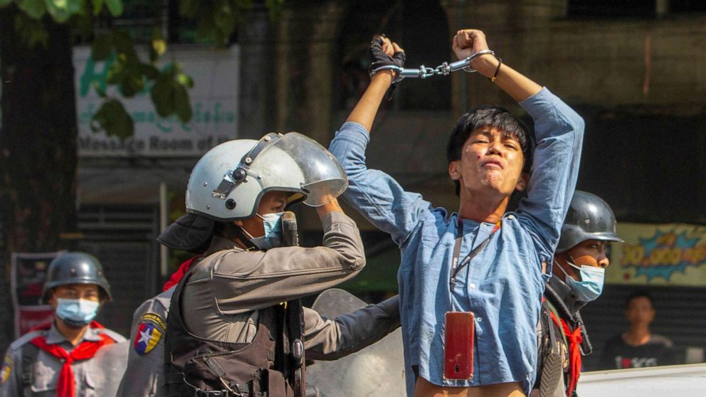 PHOTO: A pro-democracy protester is detained by riot police officers during a rally against the military coup in Yangon, Myanmar, Feb. 27, 2021. 