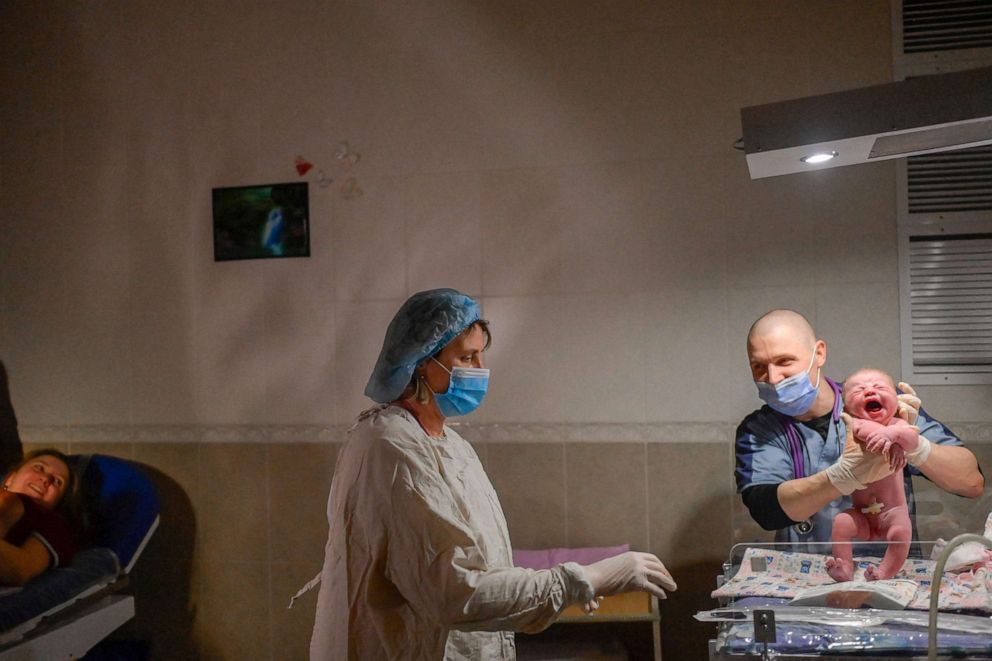 PHOTO: Aleina, left, looks on as nurses tend to her baby Snizhana seconds after giving birth in the maternity ward while sirens announce air raids in Mykolaiv on March 14, 2022.