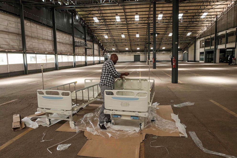 PHOTO: A man assembles beds for newly installed field hospital which will be set with 100 beds after the drill to test their capabilities for the influx of COVID-19 coronavirus patients at the Aga Khan University Hospital in Nairobi, Kenya, April 9, 2020.