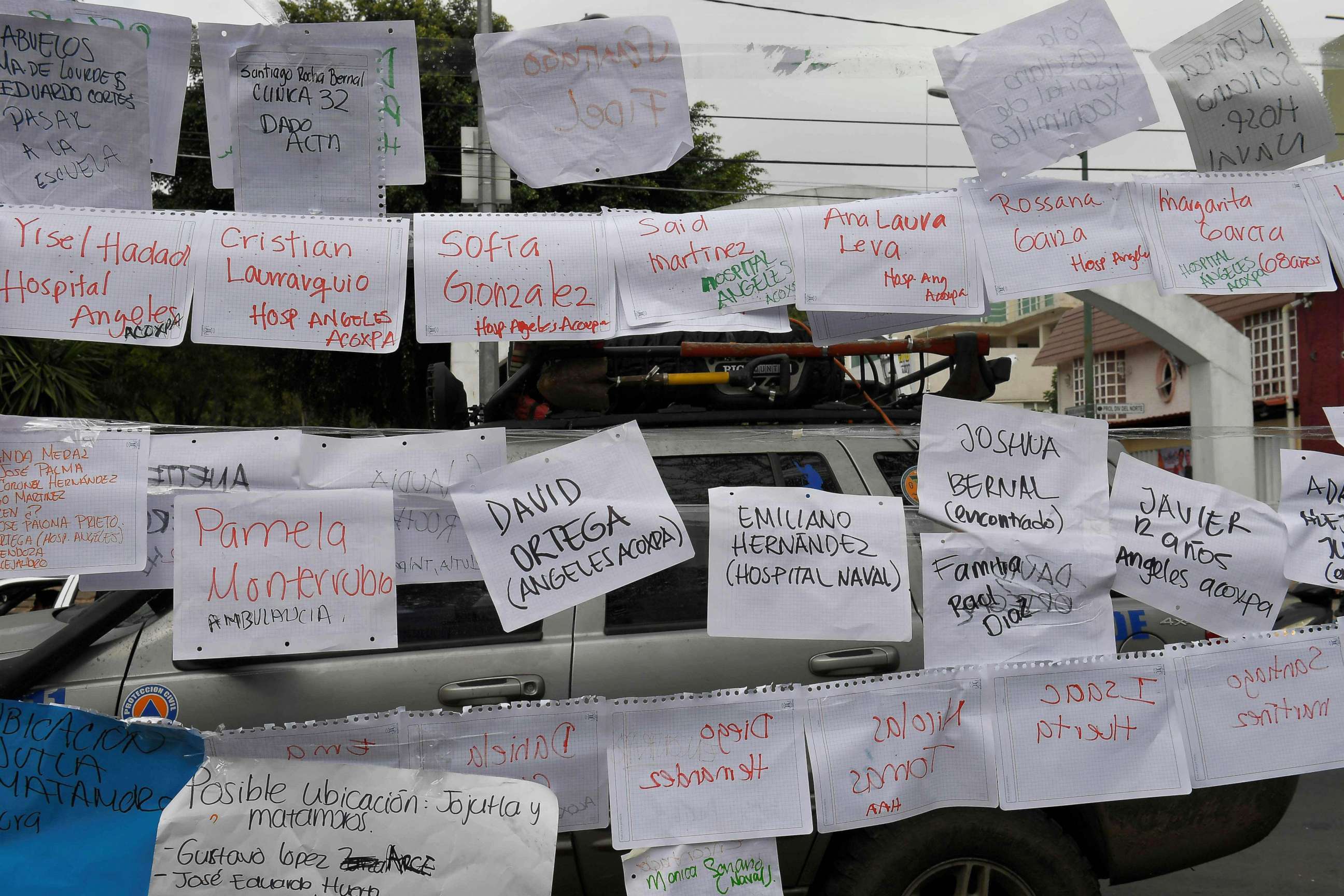 PHOTO: Sheets of paper display names and lists of people and the hospitals they are in, near a school where at least 21 children died and 30 are missing in Mexico City on Sept. 20, 2017.