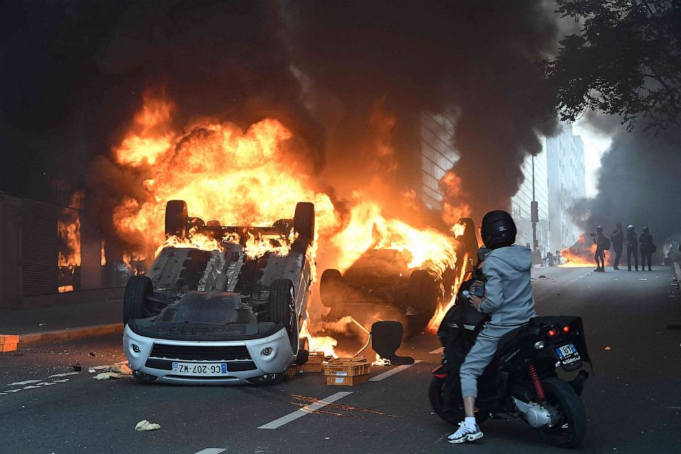 PHOTO: Cars burn in the street following a commemoration march for a teenage driver shot dead by a policeman, in the Parisian suburb of Nanterre, on June 29, 2023