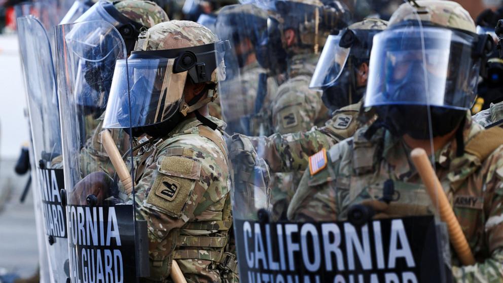PHOTO: National Guard troops wear gas masks during protests against federal immigration sweeps, in Los Angeles, June 12, 2025.