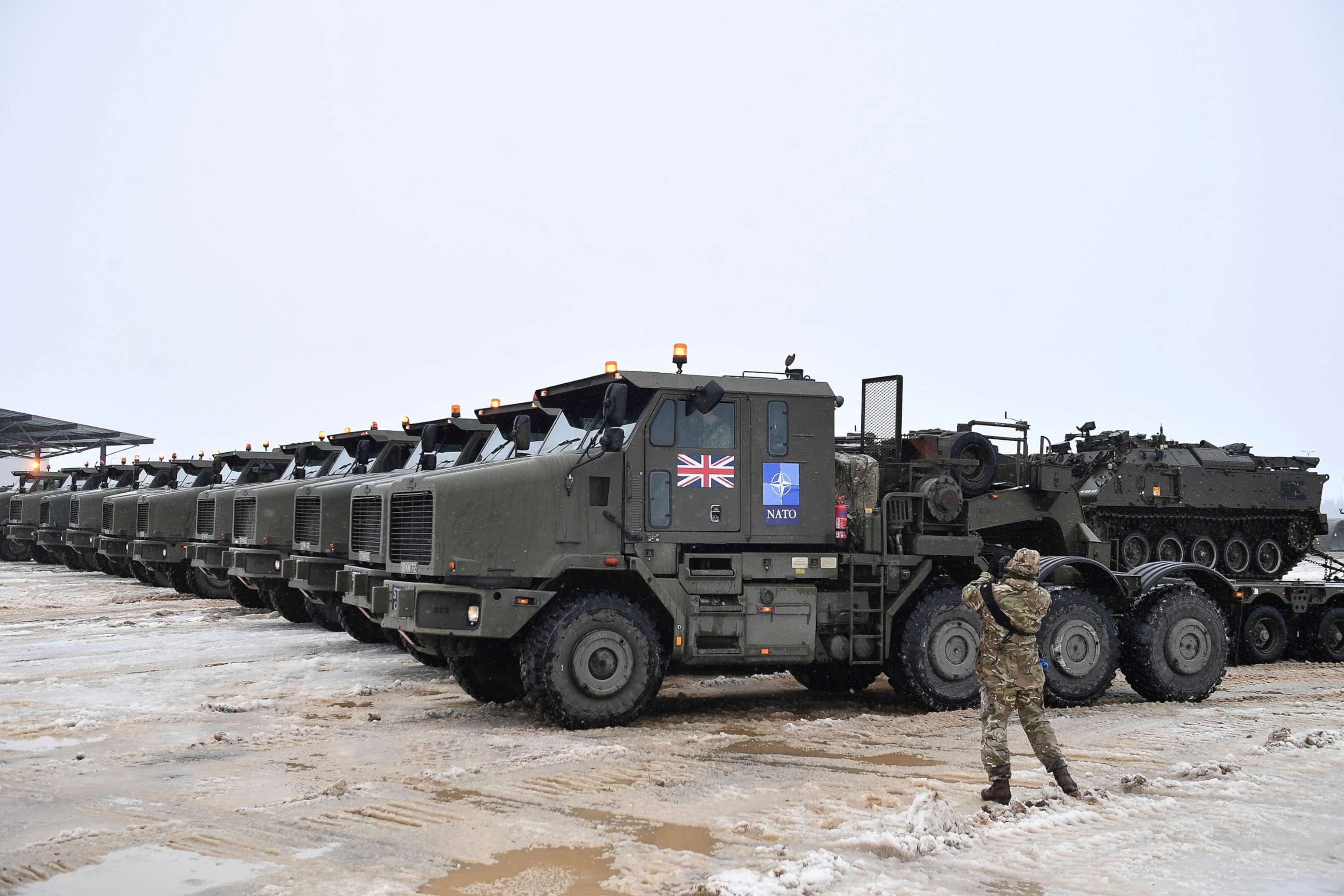 PHOTO: Tanks uploaded on military truck platforms as a part of additional British troops and military equipment arrive at Estonia's NATO Battle Group base in Tapa, Estonia, Feb. 25, 2022. 