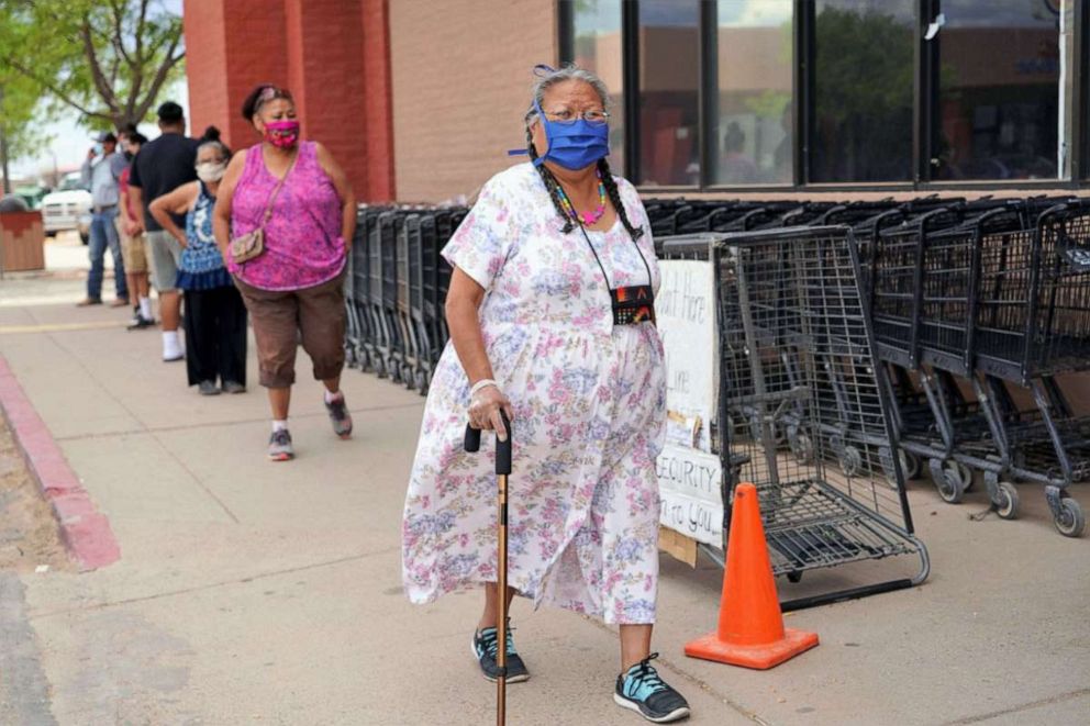 PHOTO: Shoppers wait at the entrance of a supermarket in Chinle, Ariz., June 24, 2020, while keeping a distance from each other.