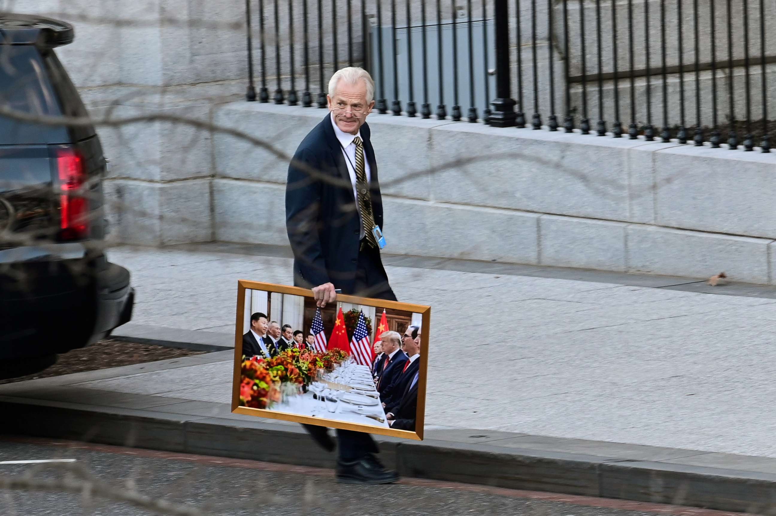 PHOTO: White House advisor Peter Navarro leaves the West Wing of the White House with a photograph of President Donald Trump and Chinese President Xi Jinping in Washington, D.C. on Jan. 13, 2021.