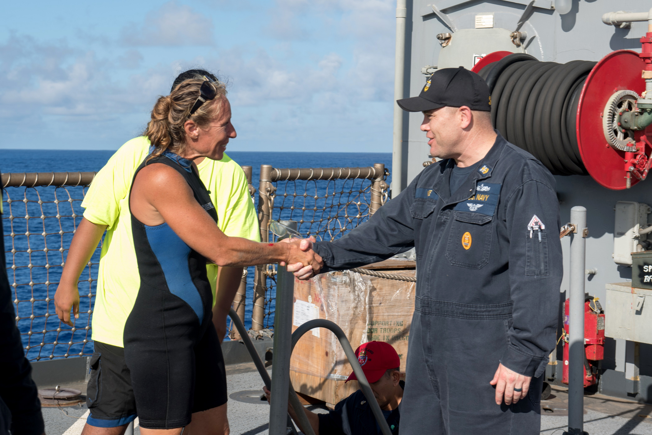PHOTO: USS Ashland (LSD 48) Command Master Chief Gary Wise welcomes aboard Jennifer Appel, an American mariner who had received assistance from Ashland crew members, Oct. 25, 2017.