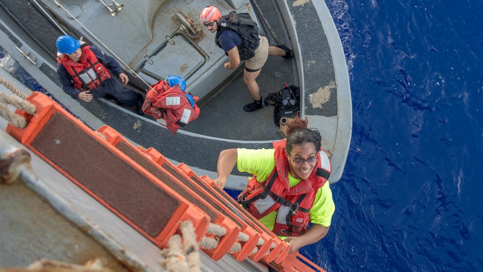 Tasha Fuiaba, an American mariner who had been sailing for five months on a damaged sailboat, climbs the accommodation ladder to board the amphibious dock landing ship USS Ashland (LSD 48), Oct. 25, 2017.