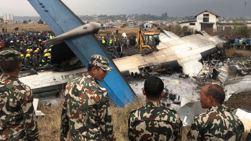 PHOTO: Wreckage of an airplane is pictured as rescue workers operate at Kathmandu airport, Nepal, March 12, 2018.
