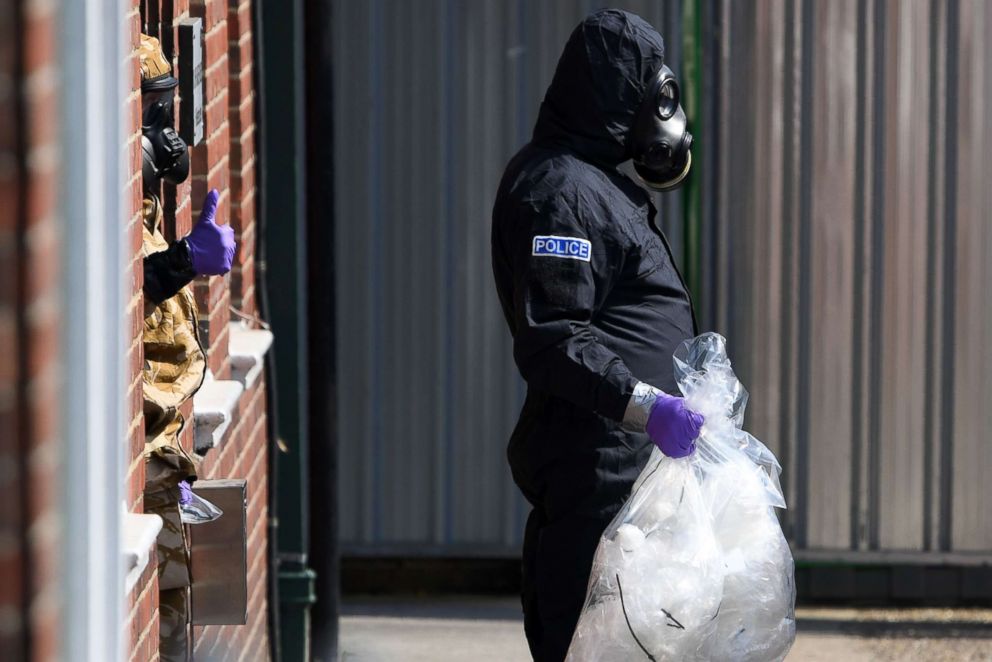 PHOTO: Investigators wearing protective suits, gloves and gas masks on Rollestone Street in Amesbury, southern England, July 6, 2018. The investigation is in connection with a British couple being exposed to the same toxin as a former Russian spy. 