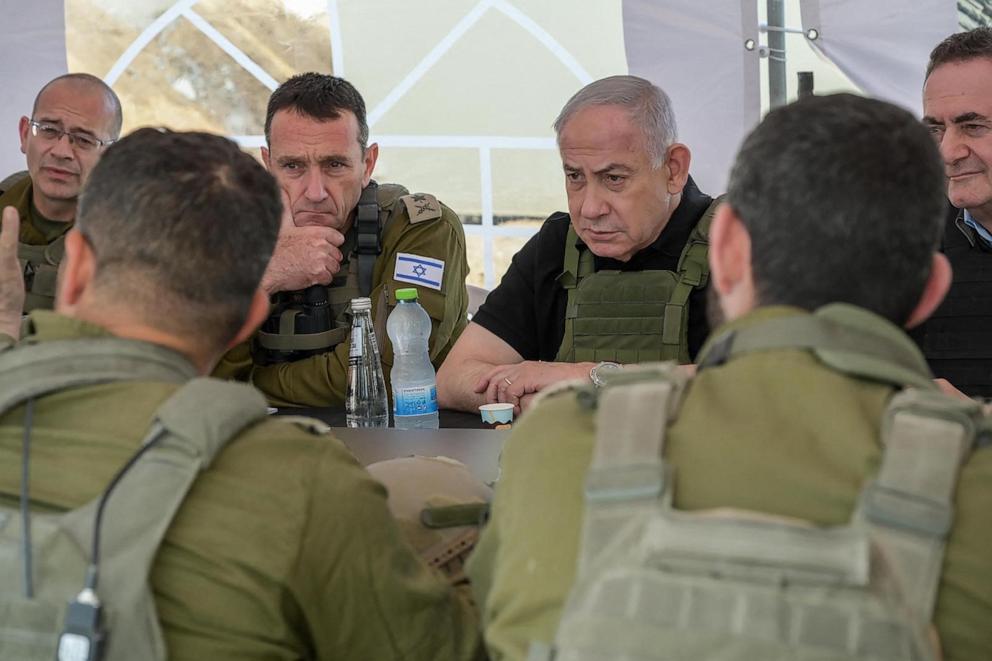 PHOTO: This handout picture released by the Government Press Office shows Israel's Prime Minister Benjamin Netanyahu, center-right, with other officials during a briefing in the Netzarim Corridor on Nov. 19, 2024. 