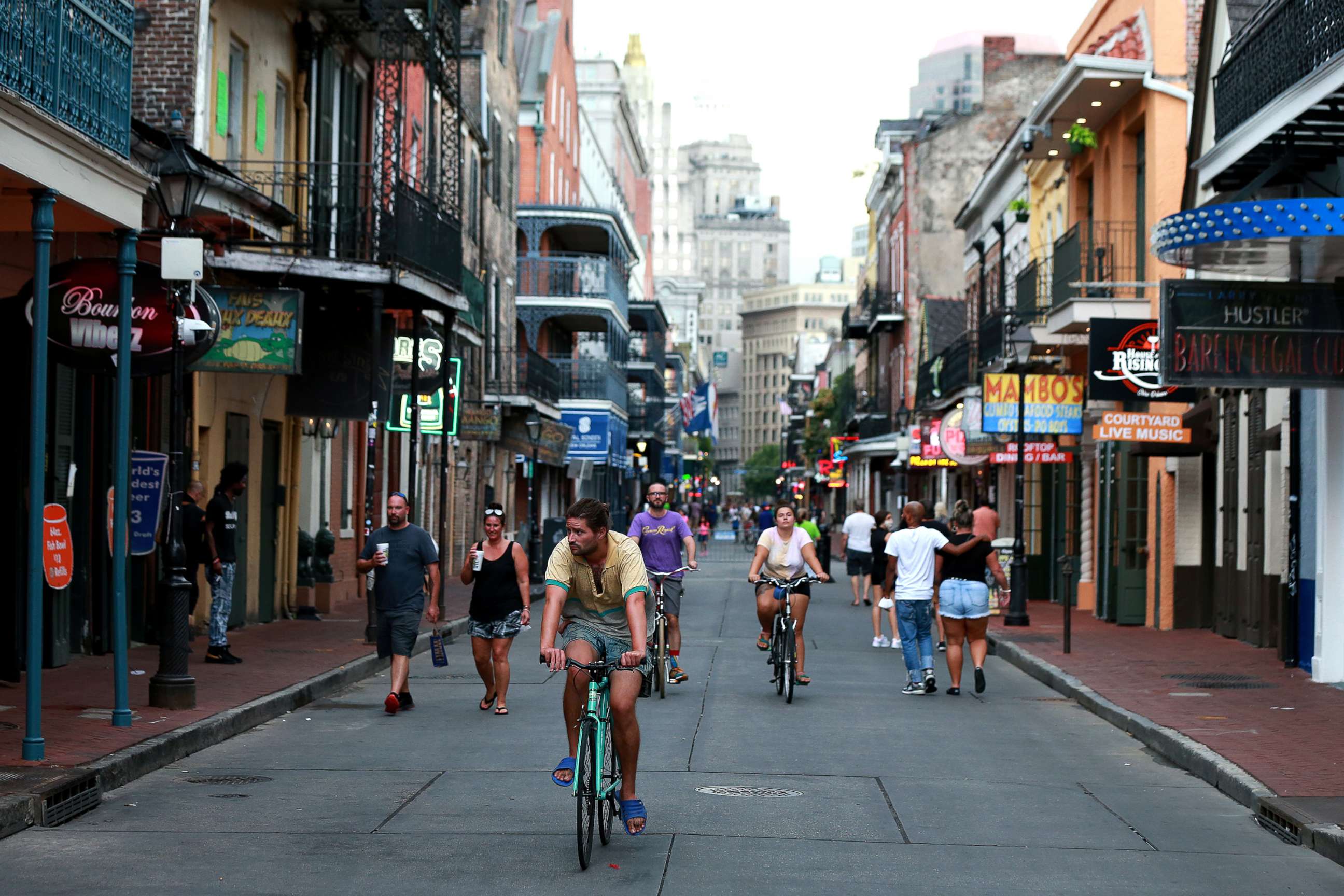 PHOTO: Pedestrians are seen walking along Bourbon Street in the French Quarter on July 14, 2020, in New Orleans.