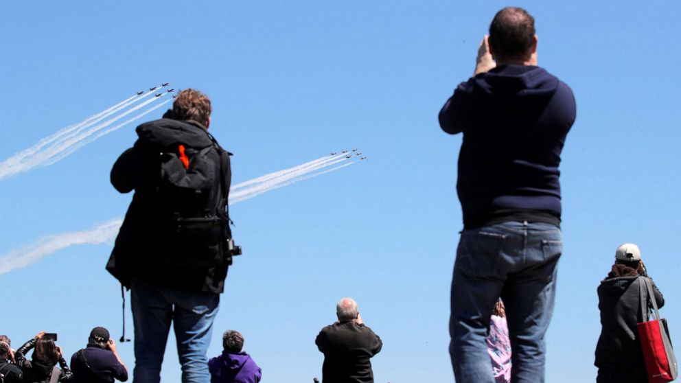 PHOTO: People watch as U.S. Navy Blue Angels and U.S. Air Force Thunderbirds demonstration teams participate in a midday flyover of New York City region to honor first responders and essential workers during the coronavirus pandemic, April 28, 2020. 