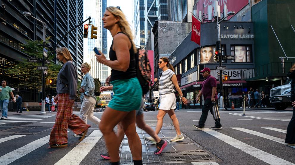 PHOTO: In this Oct. 21, 2024, file photo, people walk in Manhattan on a warm afternoon in New York.