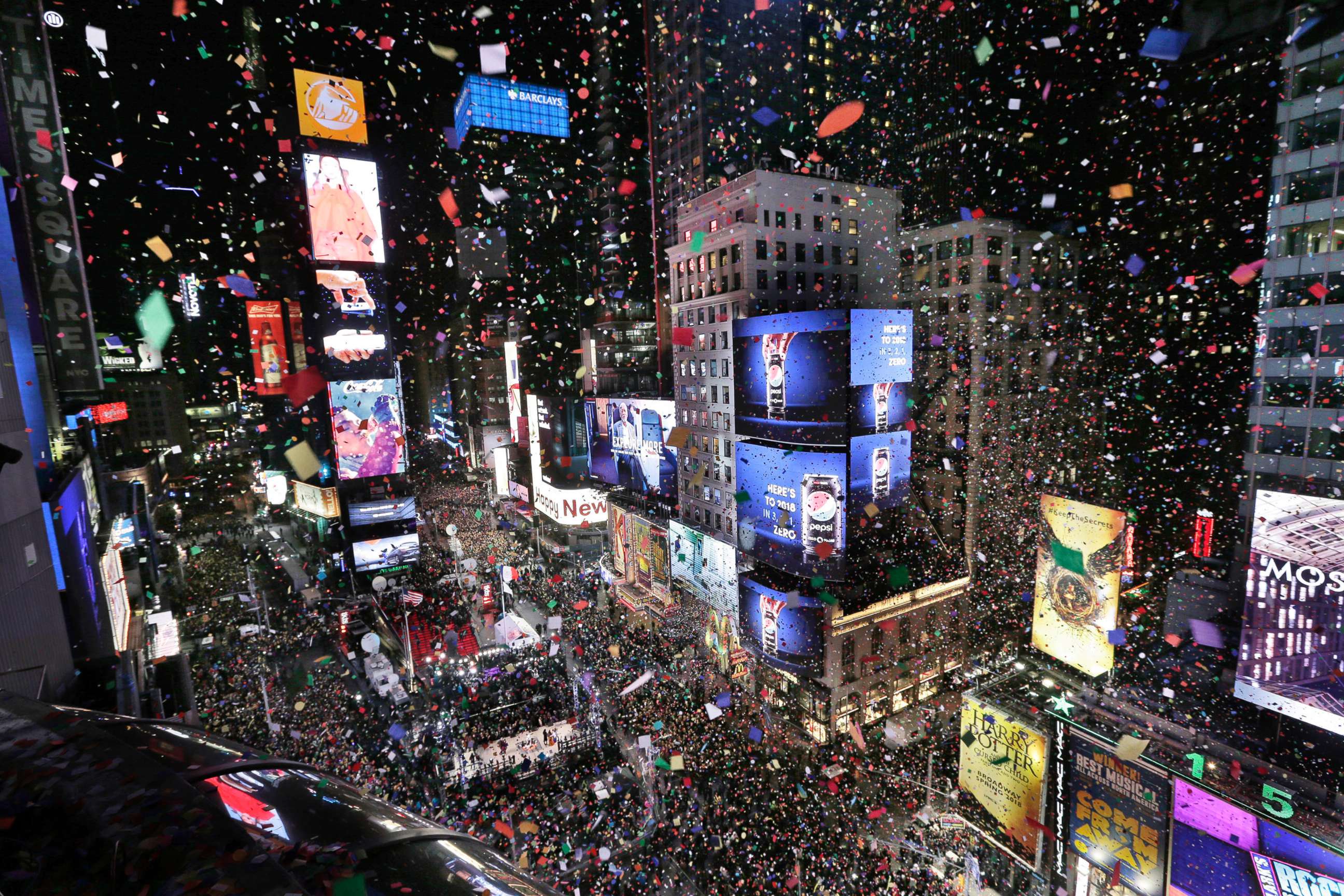 PHOTO: Confetti drops over the crowd as the clock strikes midnight during the New Year's celebration in Times Square, New York, Jan. 1, 2018. 