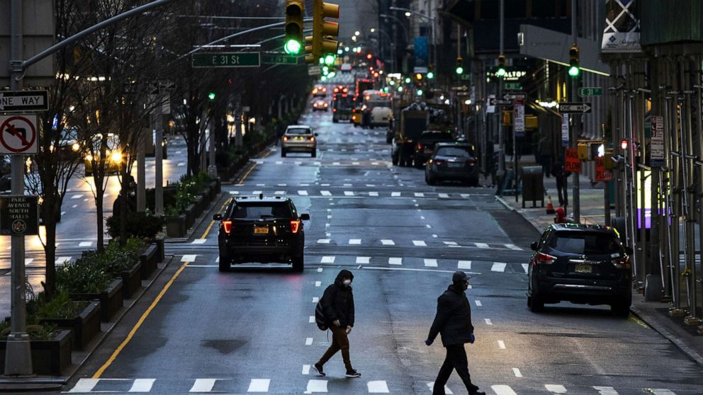 PHOTO: People cross Park Avenue after it was announced that some streets will be shut as lockdown continues in response to the coronavirus (COVID-19) outbreak, March 27, 2020, in New York City.