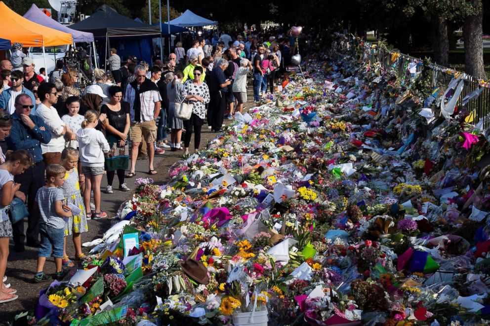 PHOTO: Floral tributes to those who were gunned down at the two mosques are seen against a wall bordering the Botanical Garden in Christchurch on March 19, 2019.