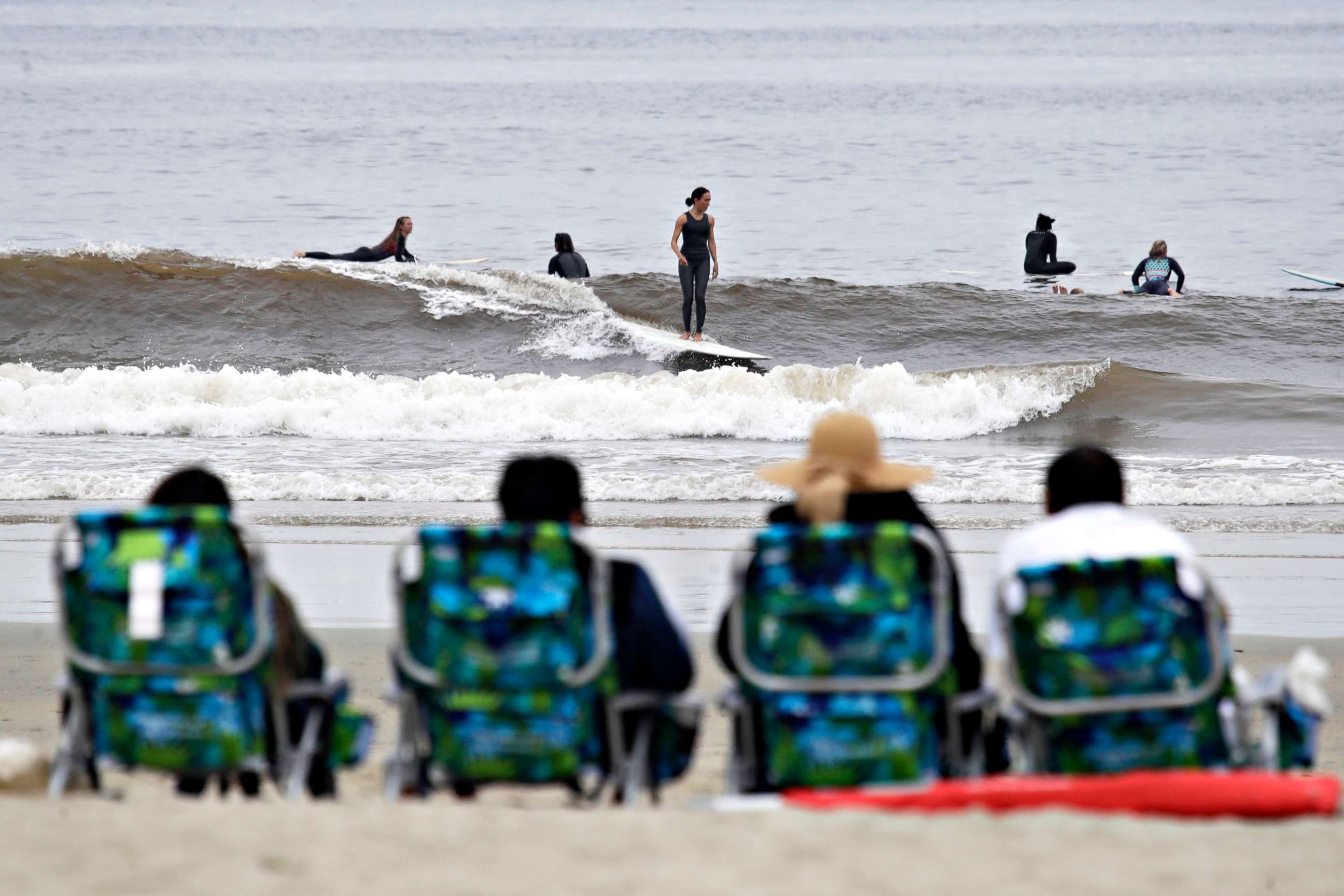 PHOTO:People sit on beach chairs and watch surfers, April 30, 2020, in Newport Beach, Calif. A memo sent to California police chiefs says Gov. Gavin Newsom will order all beaches and state parks closed starting May 1 to curb the spread of the coronavirus.