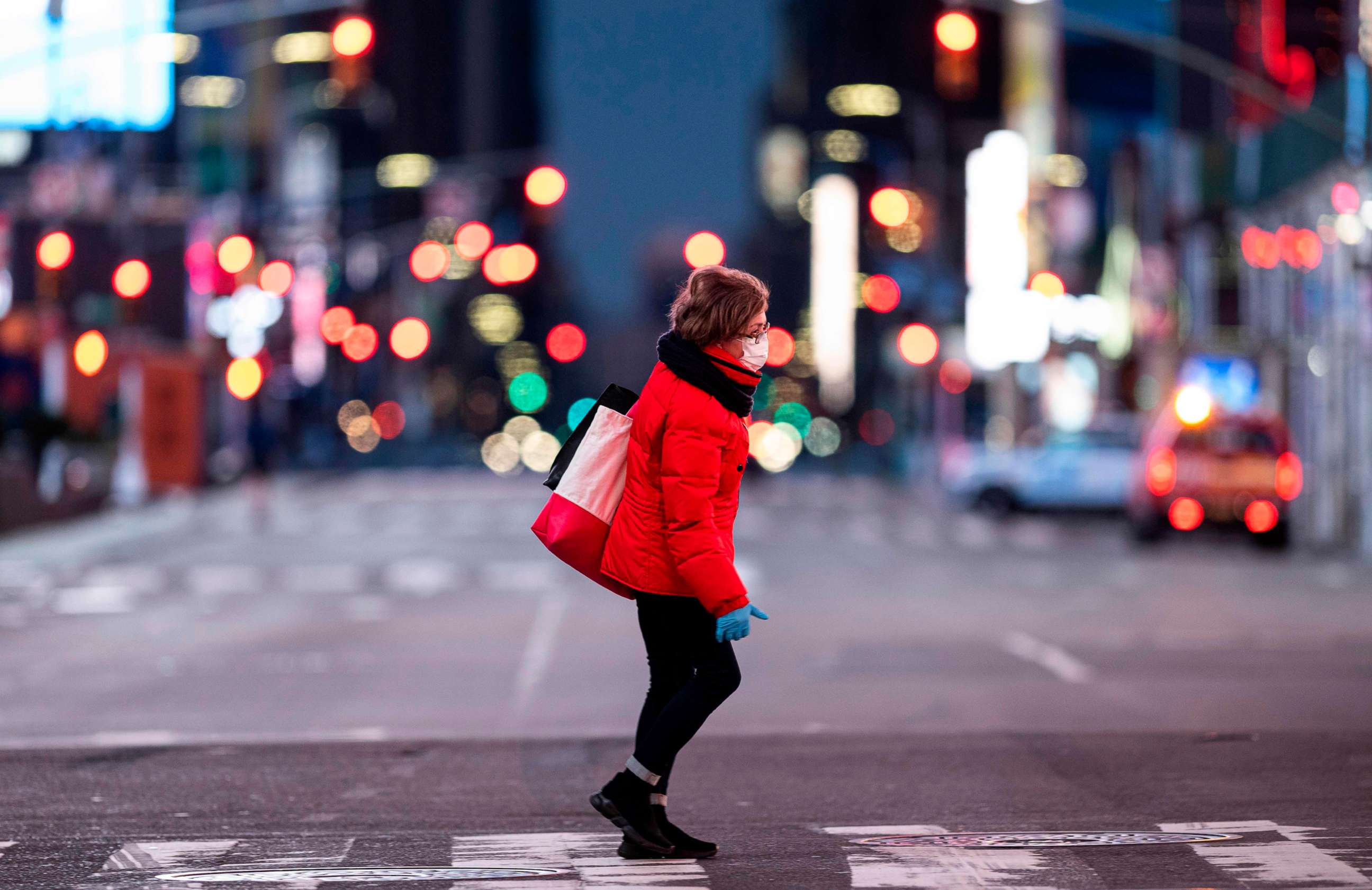 PHOTO: A woman walks through an almost-deserted Times Square in the early morning hours, on April 23, 2020, in New York City.