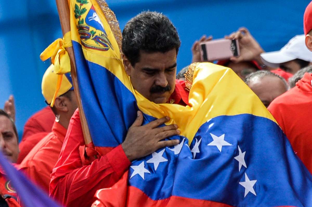 PHOTO: Venezuelan President Nicolas Maduro holds a national flag during the closing of the campaign to elect a Constituent Assembly that would rewrite the constitution, in Caracas, July 27, 2017. 