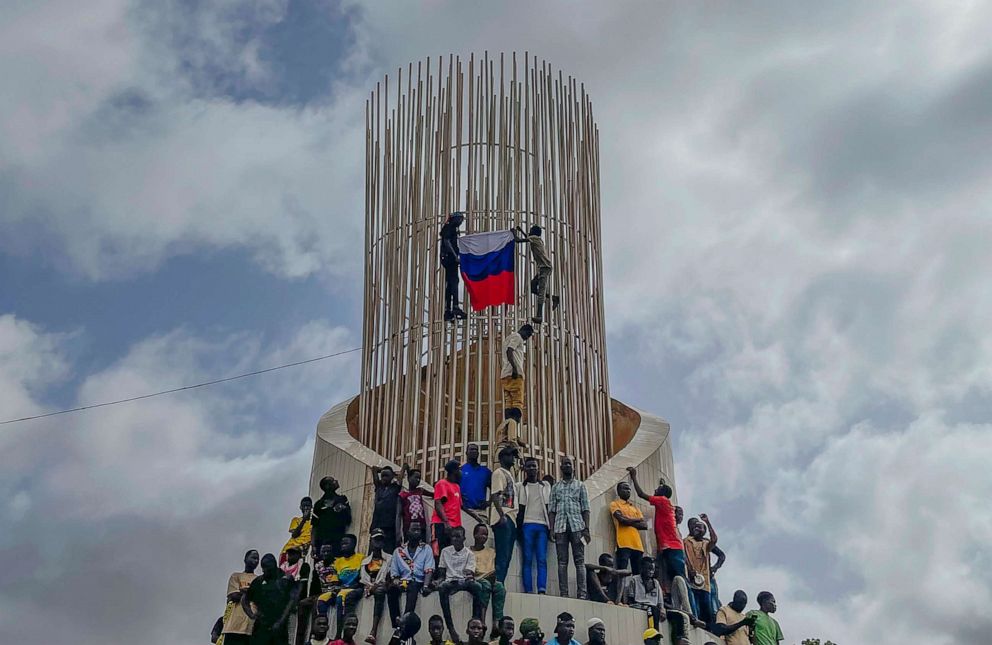 PHOTO: Supporters of Niger's ruling junta hold a Russian flag at the start of a protest called to fight for the country's freedom and push back against foreign interference in Niamey, Niger, Aug. 3, 2023.