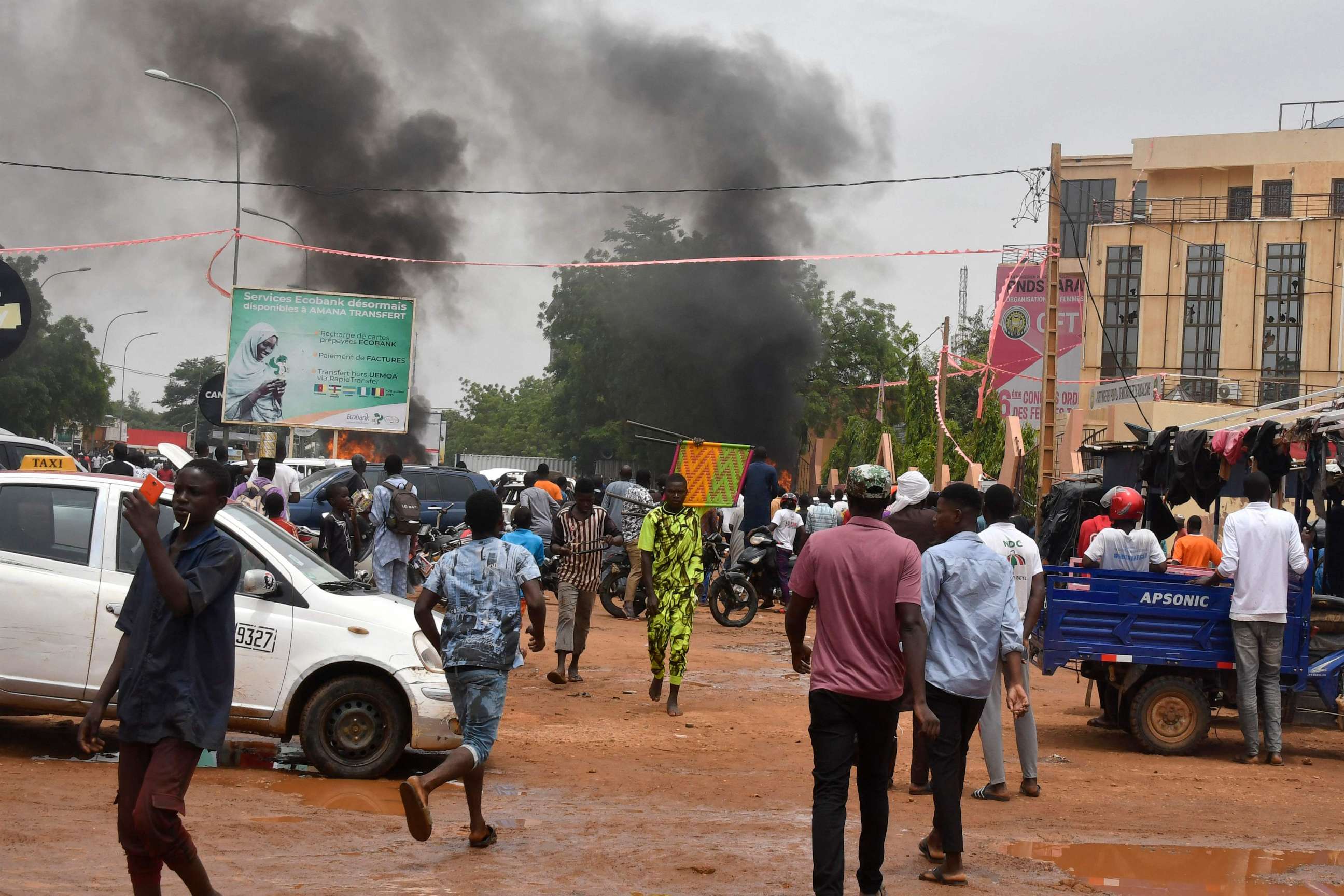 PHOTO: TOPSHOT - A view of billowing smoke as supporters of the Nigerien defence and security forces attack the headquarters of the Nigerien Party for Democracy and Socialism (PNDS), the party of overthrown President Bazoum, in Niamey on July 27, 2023.