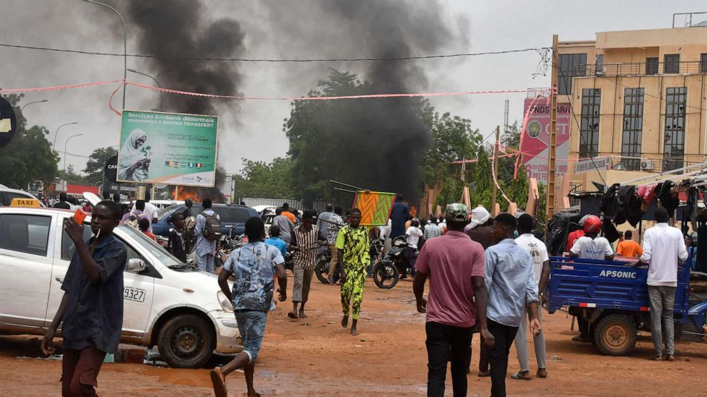 PHOTO: TOPSHOT - A view of billowing smoke as supporters of the Nigerien defence and security forces attack the headquarters of the Nigerien Party for Democracy and Socialism (PNDS), the party of overthrown President Bazoum, in Niamey on July 27, 2023.
