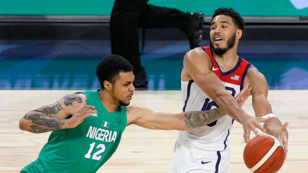 PHOTO: Michael Gbinije #12 of Nigeria knocks the ball away from Jayson Tatum #10 of the United States during an exhibition game at Michelob ULTRA Arena ahead of the Tokyo Olympic Games, July 10, 2021, in Las Vegas.