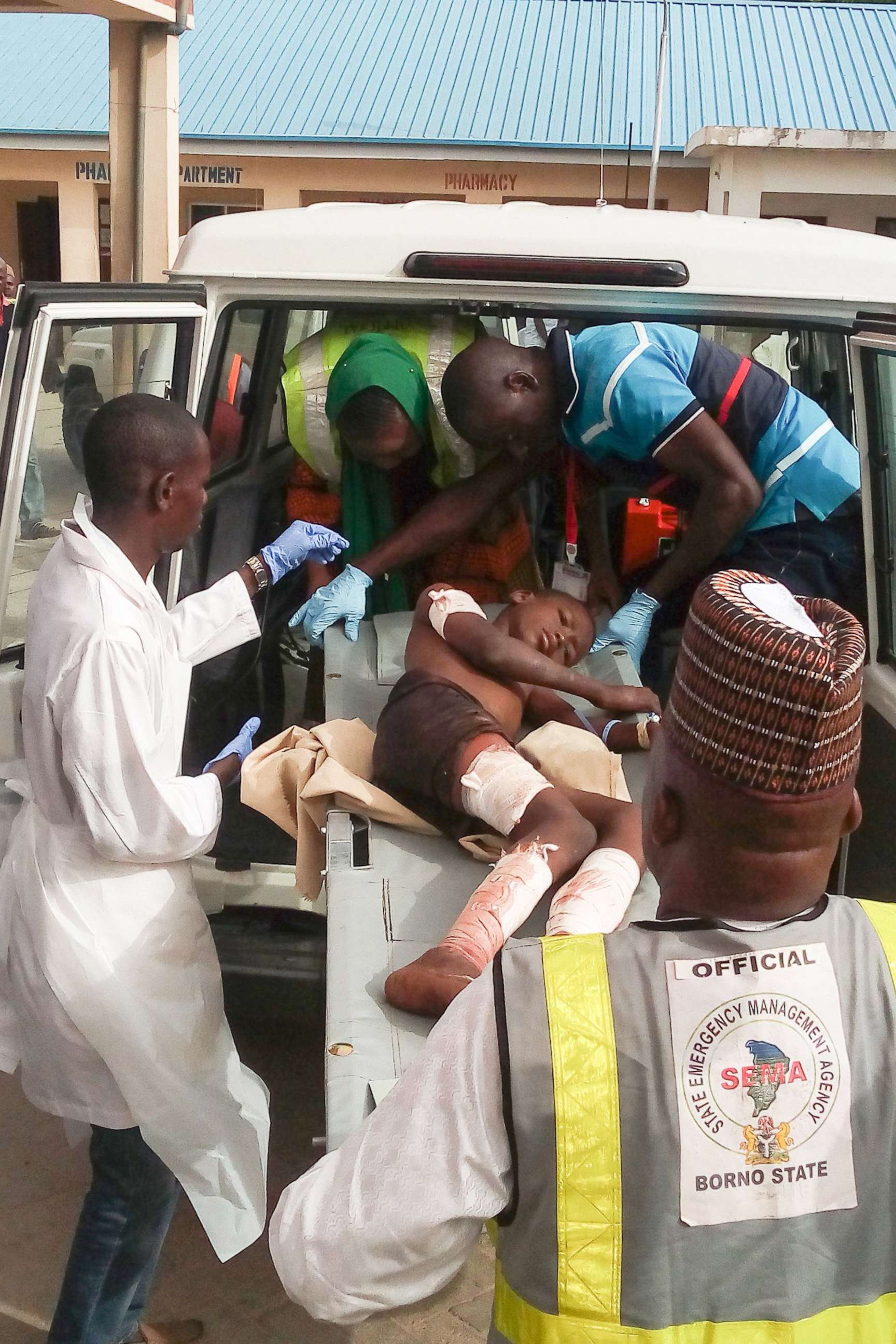 PHOTO: A young victim of a blast, by suspected Boko Haram jihadists, is carried by paramedics the hospital in Maiduguri, Nigeria, June 17, 2018.