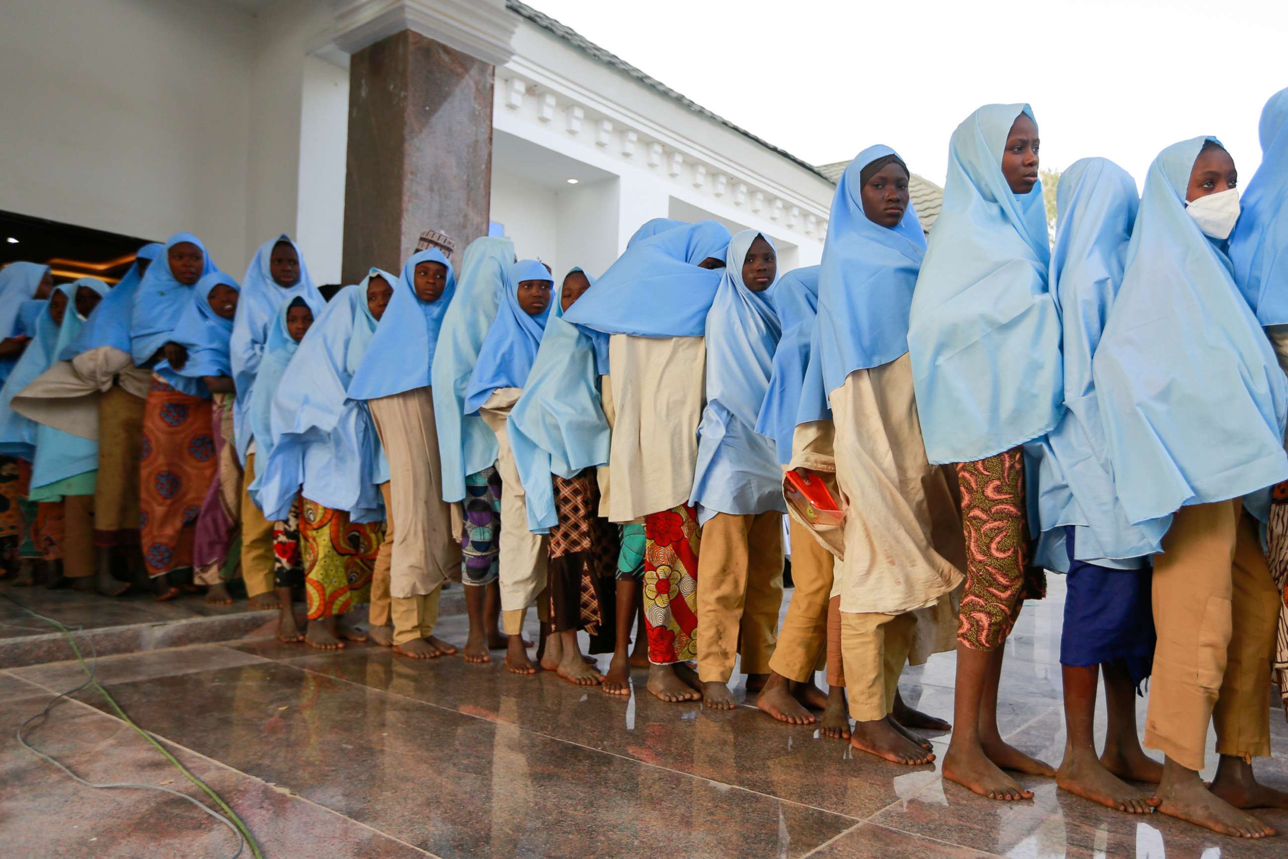 PHOTO: Girls who were kidnapped from a boarding school in the northwest Nigerian state of Zamfara, walk in line after their release in Zamfara, Nigeria, March 2, 2021.  