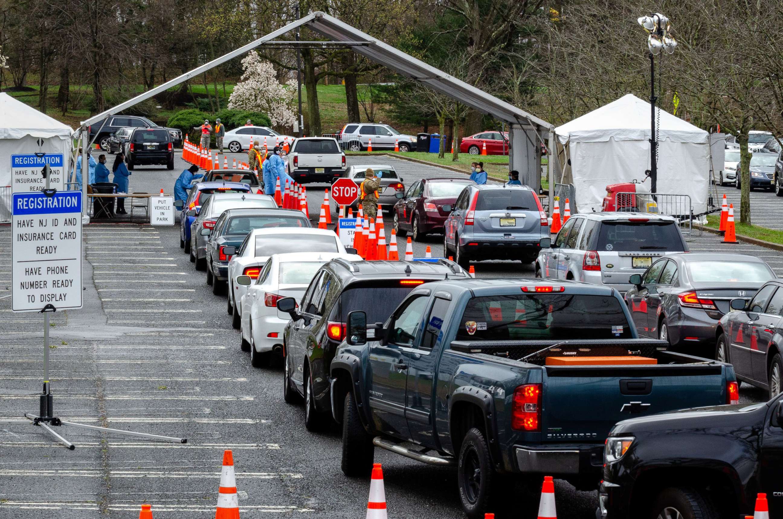 PHOTO: Cars form lines at a federally-supported drive-thru testing site for coronavirus disease at PNC Bank Arts Center in Holmdel, New Jersey, April 4, 2020. 