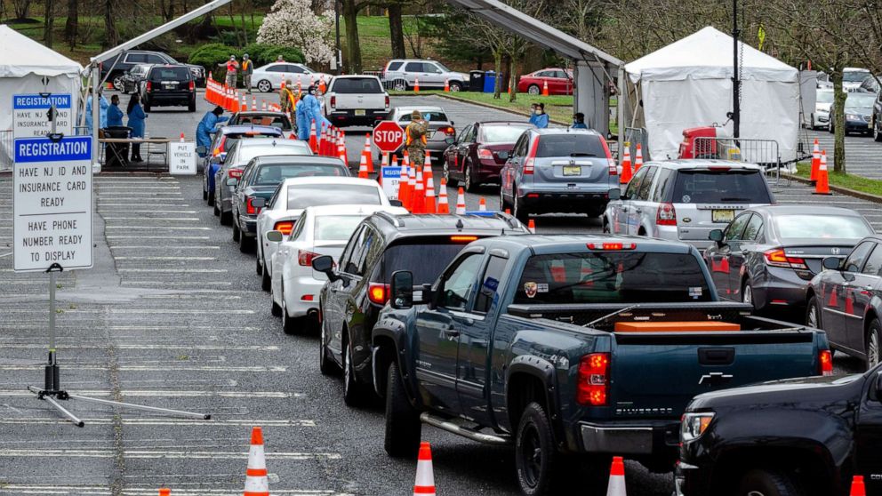 PHOTO: Cars form lines at a federally-supported drive-thru testing site for coronavirus disease at PNC Bank Arts Center in Holmdel, New Jersey, April 4, 2020. 