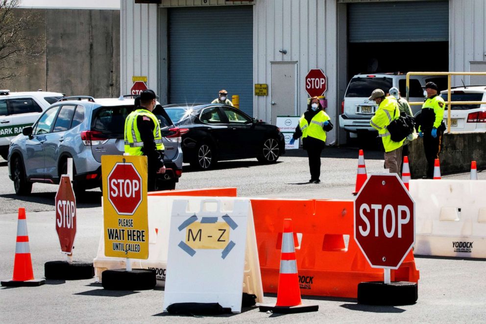 PHOTO: New Jersey police officers and health care workers at a saliva-based coronavirus disease (COVID-19) testing site during the outbreak of the coronavirus disease (COVID-19) in Edison, New Jersey, April 15, 2020. 