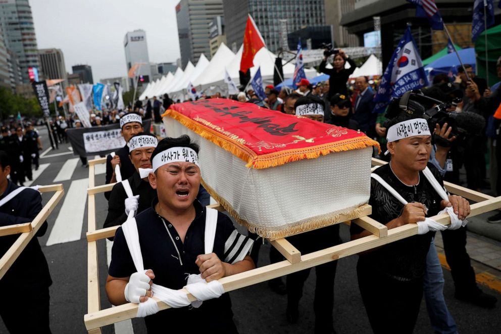 PHOTO: People carrying mock coffins of a 42-year-old defector mother and her 6-year-old son who were found dead of starvation in Seoul, South Korea, Sept. 21, 2019.    