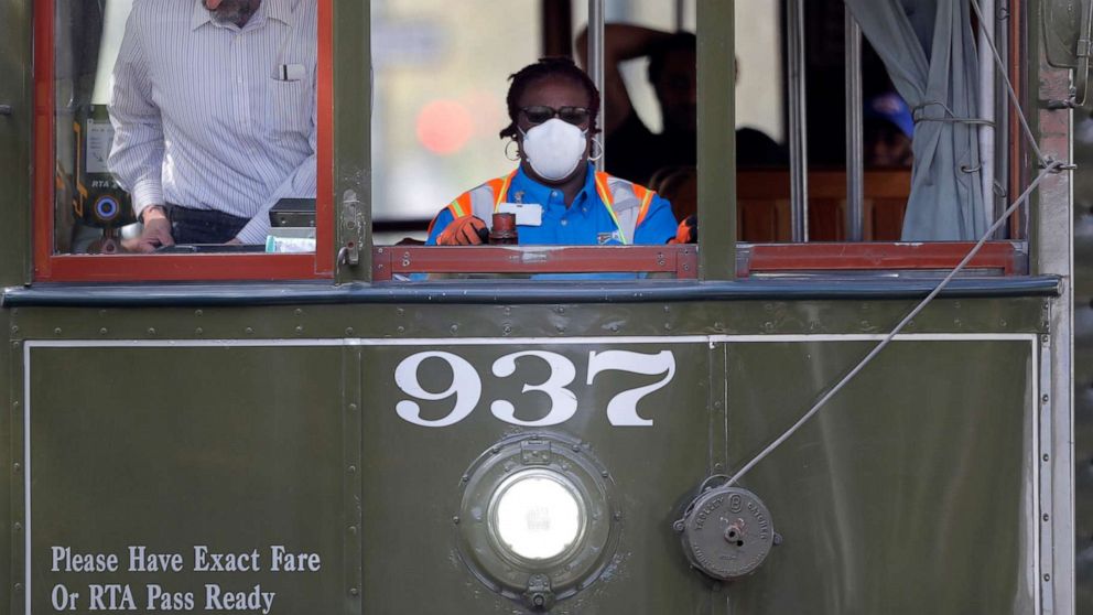 PHOTO: A streetcar conductor wears a mask due to the coronavirus pandemic as she runs her route on St. Charles Ave. in New Orleans, March 19, 2020.