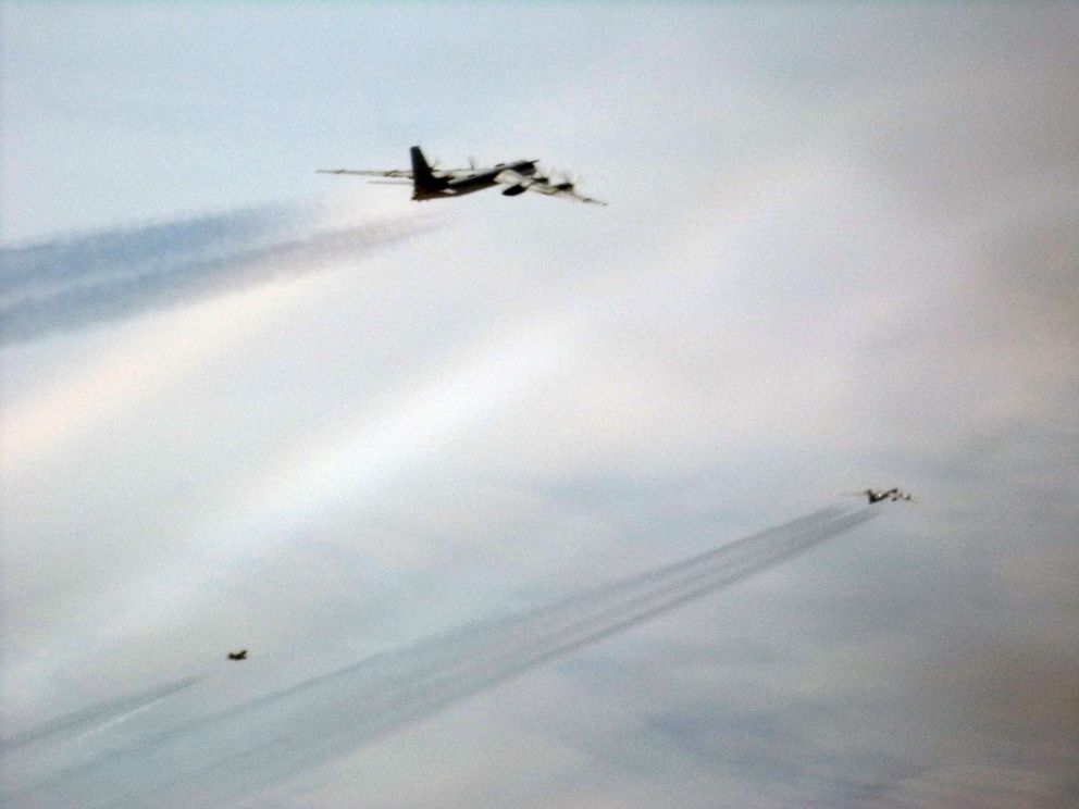 PHOTO: A Russian Tupolev Tu-95 bomber is intercepted by a U.S. Air Force F-22 Raptor off the coast of Alaska on May 20, 2019.