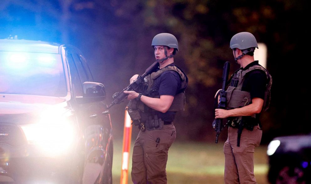 PHOTO: Law enforcement stand at the entrance to Neuse River Greenway Trail parking at Abington Lane following a shooting in Raleigh, NC, Oct. 13, 2022