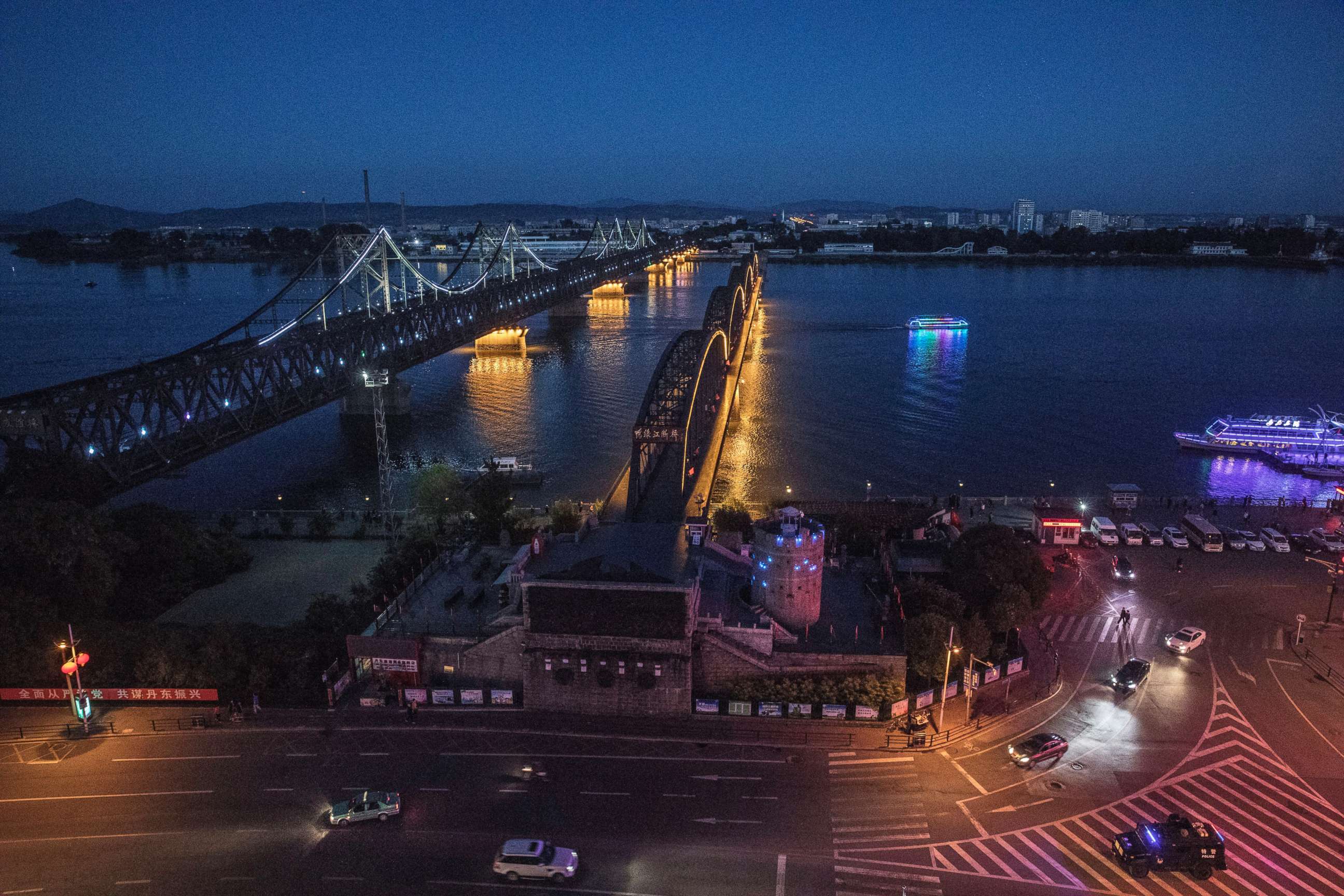 PHOTO: The "Friendship Bridge", left, and "Broken Bridge" on the Yalu river from the border city of Dandong in northern China across from the city of Sinuiju, North Korea on May 23, 2017. 