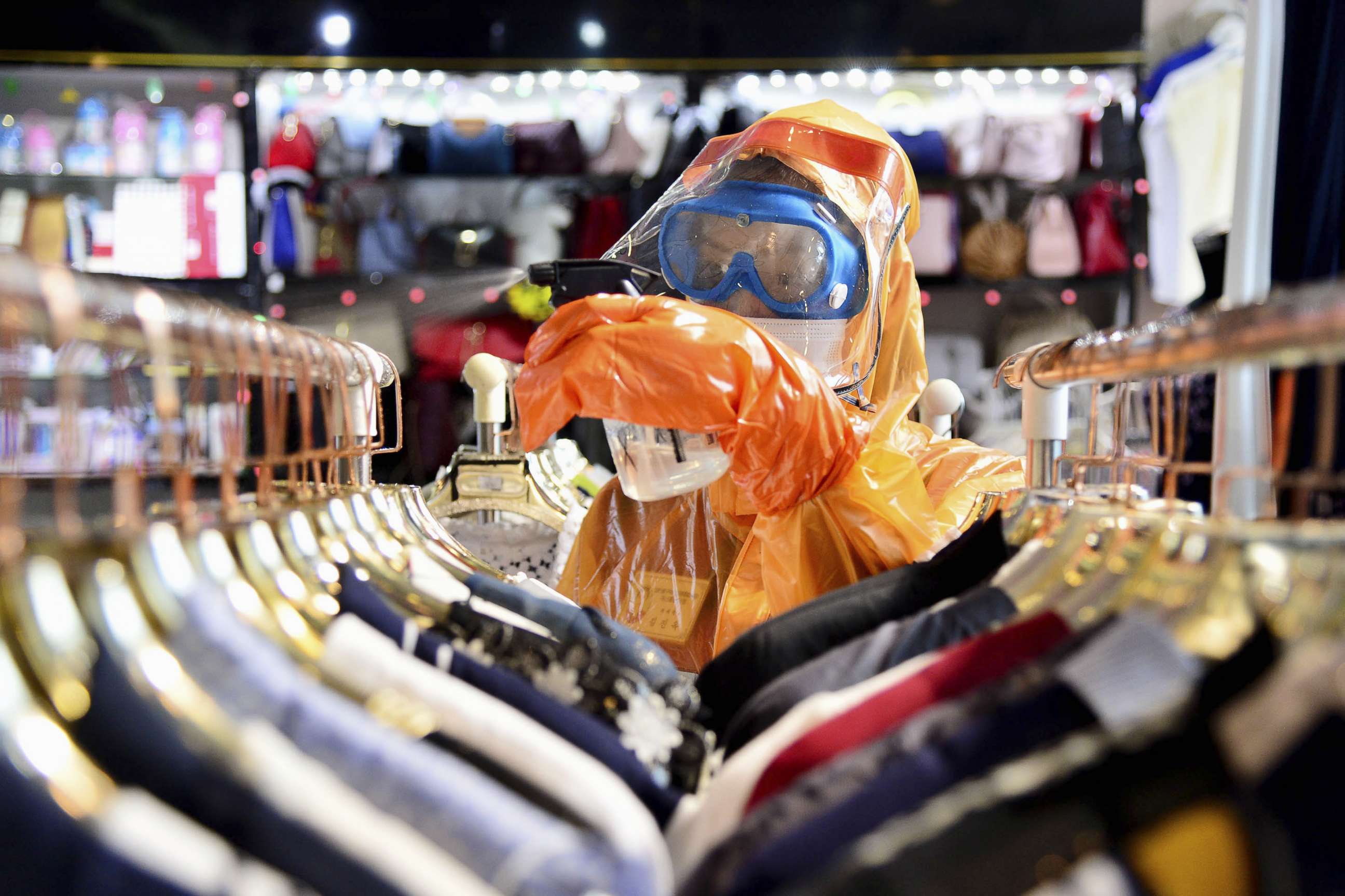 PHOTO: A worker in a protective suit disinfects a store in Pyongyang, North Korea, June 27, 2022.