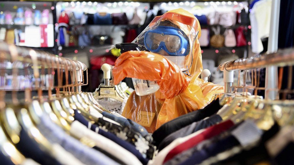 PHOTO: A worker in a protective suit disinfects a store in Pyongyang, North Korea, June 27, 2022.