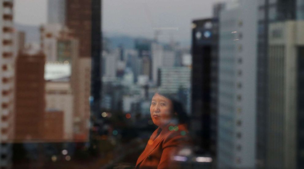 PHOTO: Kim Ryon Hui, 48, is reflected on a window as she poses for a photograph in Seoul, South Korea, Nov. 14, 2017.