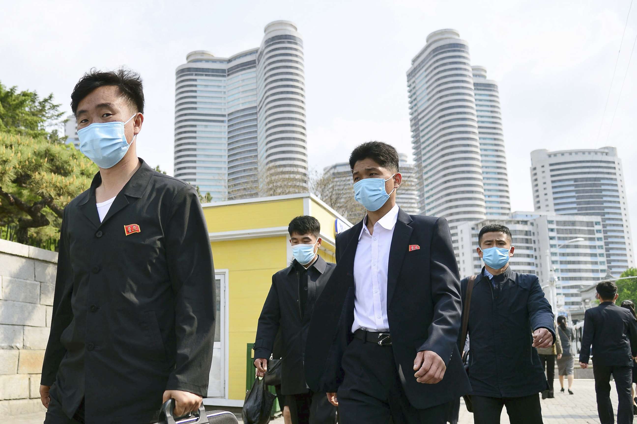 PHOTO: People wear face masks walk in Pyongyang, North Korea on May 6, 2022.