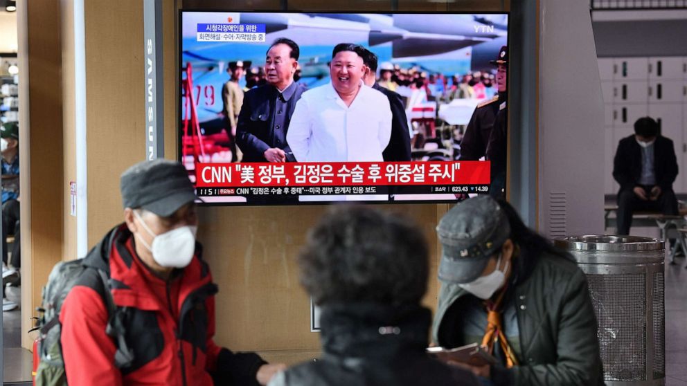 PHOTO: People watch a television news broadcast showing file footage of North Korean leader Kim Jong Un, at a railway station, in Seoul on April 21, 2020.