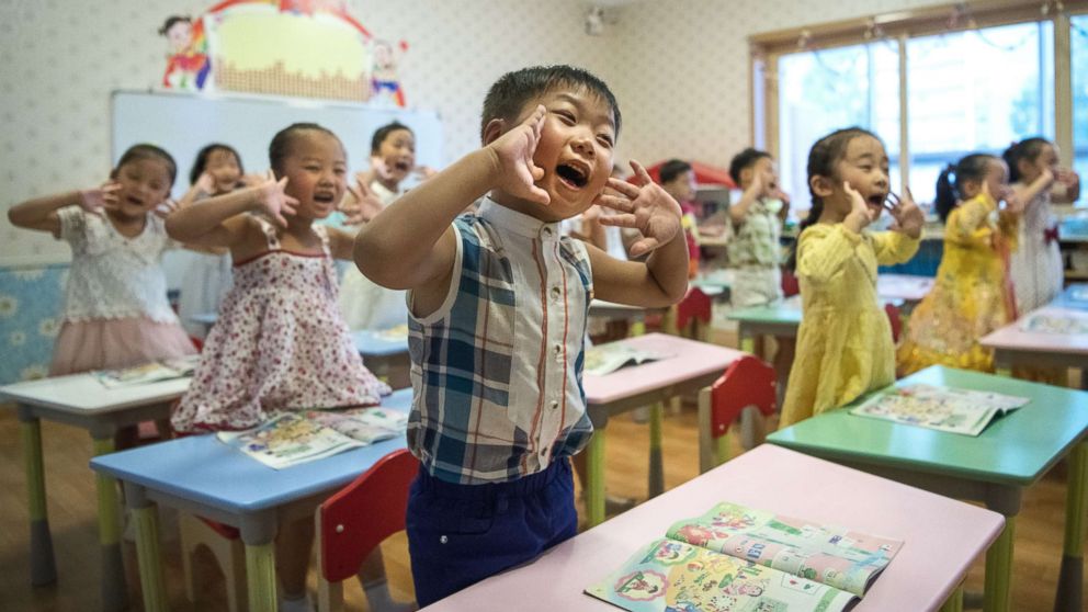 Children gesture and shout at the instruction of a teacher at Gyongsang Kindergarten on Aug. 23, 2018 in Pyongyang, North Korea.