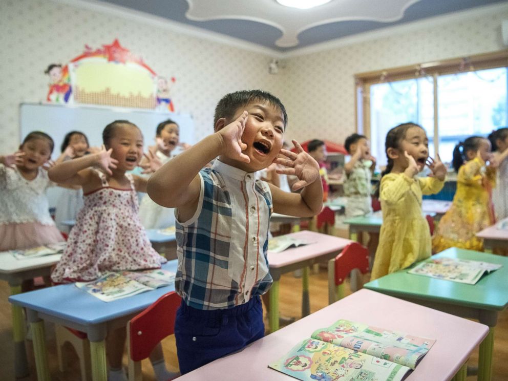 PHOTO: Children gesture and shout at the instruction of a teacher at Gyongsang Kindergarten on Aug. 23, 2018 in Pyongyang, North Korea.