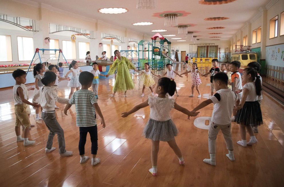 PHOTO: A teacher leads children in a play session at Gyongsang Kindergarten on Aug. 23, 2018 in Pyongyang, North Korea. 