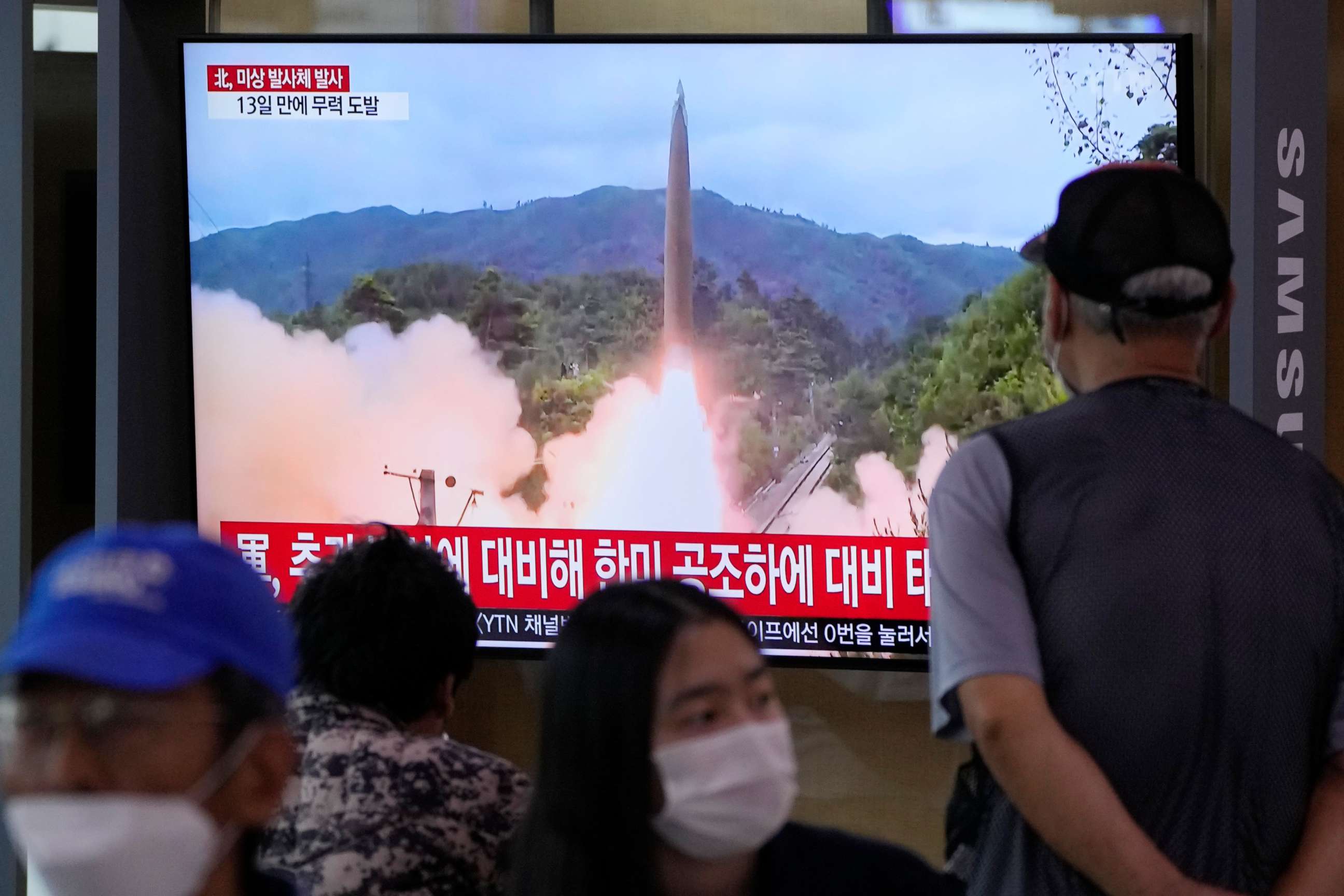 PHOTO: People watch a news program on a television at the railway station in Seoul, South Korea, showing a file image of North Korea's missile launch on Sept. 28, 2021.