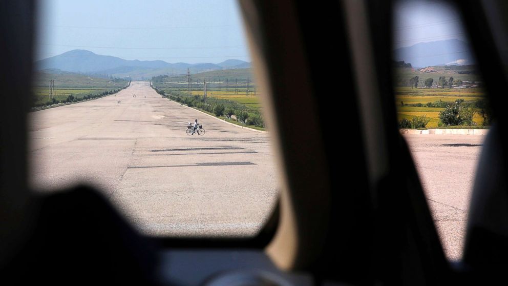 PHOTO: A biker crosses a motorway from Pyongyang to Nampo, a city and seaport located on the west coast of North Korea, Sept. 12, 2018.