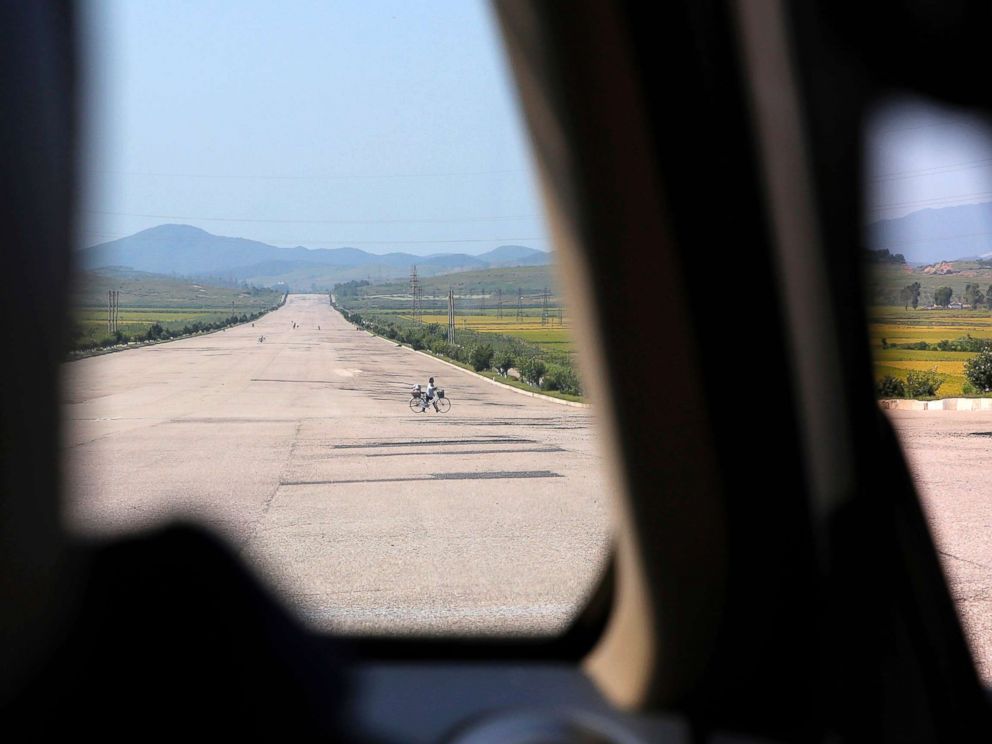 PHOTO: A biker crosses a motorway from Pyongyang to Nampo, a city and seaport located on the west coast of North Korea, Sept. 12, 2018.