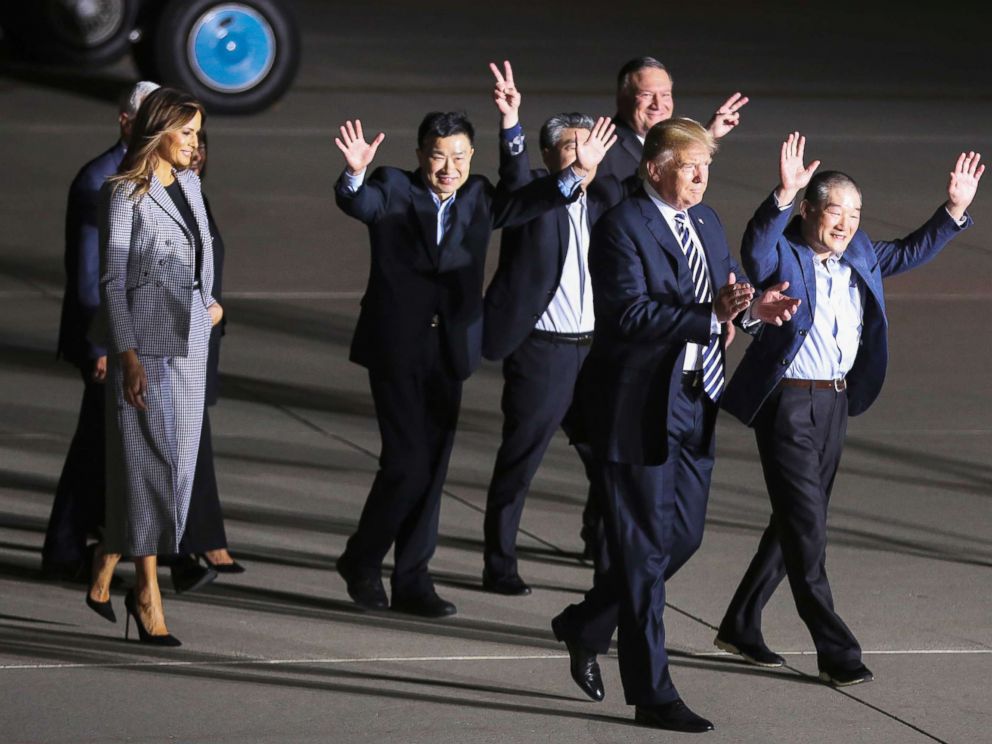 PHOTO: President Donald Trump, first lady Melania Trump Vice President Mike Pence and Secretary of State Mike Pompeo walk with the Americans formerly held hostage in North Korea, at Joint Base Andrews, Maryland on May 10, 2018.