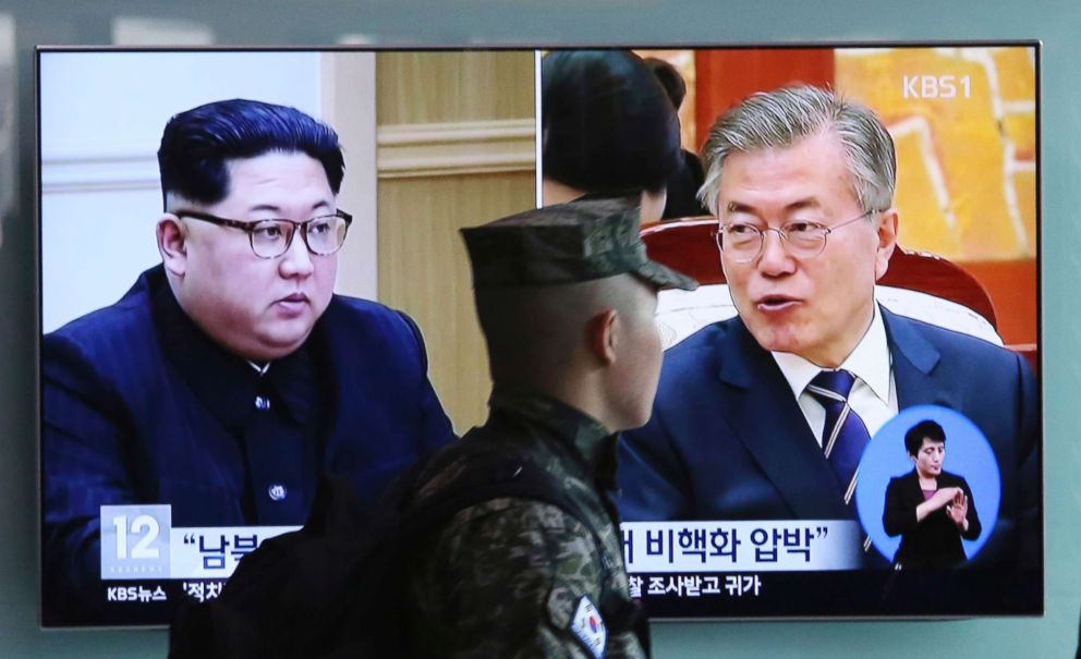 PHOTO: A South Korean marine soldier passes by a TV screen showing file footage of South Korean President Moon Jae-in and North Korean leader Kim Jong Un, left, during a news program at the Seoul Railway Station in Seoul, South Korea, April 18, 2018.